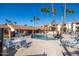 Community pool with surrounding lounge chairs at 17404 N 99Th Ave # 205, Sun City, AZ 85373