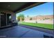 Covered patio overlooks a spacious backyard with artificial turf at 18370 W Goldenrod St, Goodyear, AZ 85338