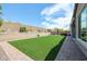 Artificial turf backyard with a brick patio at 18370 W Goldenrod St, Goodyear, AZ 85338