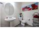 Clean and modern bathroom with pedestal sink and oval mirror at 18370 W Goldenrod St, Goodyear, AZ 85338