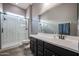 Bathroom with a walk-in shower and dark vanity at 18370 W Goldenrod St, Goodyear, AZ 85338