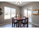 Bright dining area with table and chairs near sliding door at 18370 W Goldenrod St, Goodyear, AZ 85338