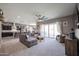 Bright living room with L-shaped sectional sofa and sliding doors at 18370 W Goldenrod St, Goodyear, AZ 85338