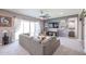 Bright living room with L-shaped sectional sofa and sliding doors at 18370 W Goldenrod St, Goodyear, AZ 85338