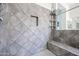 Modern shower with gray tile and built-in shelving at 18370 W Goldenrod St, Goodyear, AZ 85338