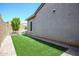 Side yard with artificial turf and a tree at 18370 W Goldenrod St, Goodyear, AZ 85338