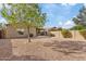 Backyard with gravel, tree, and patio at 1866 E Dust Devil Dr, San Tan Valley, AZ 85143