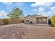 Spacious backyard with gravel landscaping and covered patio at 1866 E Dust Devil Dr, San Tan Valley, AZ 85143