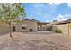 Spacious backyard with gravel landscaping and covered patio at 1866 E Dust Devil Dr, San Tan Valley, AZ 85143