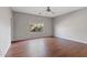 Simple bedroom with wood-look flooring and a window with blinds at 1866 E Dust Devil Dr, San Tan Valley, AZ 85143