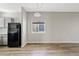 Simple dining area with wood-look flooring and a window with blinds at 1866 E Dust Devil Dr, San Tan Valley, AZ 85143