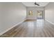 Bright living room with wood-look floors and sliding glass doors at 1866 E Dust Devil Dr, San Tan Valley, AZ 85143