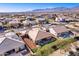 Aerial view of house and neighborhood with mountain backdrop at 18904 W Mercer Ln, Surprise, AZ 85388