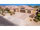 Single-story home with a two-car garage and landscaped yard at 18904 W Mercer Ln, Surprise, AZ 85388