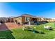 Artificial turf backyard with a bench and decorative elements at 18904 W Mercer Ln, Surprise, AZ 85388