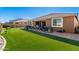 Spacious backyard with artificial turf and a patio at 18904 W Mercer Ln, Surprise, AZ 85388