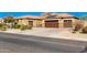 House exterior with a large driveway and two-car garage at 18904 W Mercer Ln, Surprise, AZ 85388