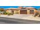 Two-car garage and landscaped yard at 18904 W Mercer Ln, Surprise, AZ 85388