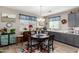 Eat-in kitchen with gray cabinets and a charming table setting at 18904 W Mercer Ln, Surprise, AZ 85388