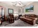 Relaxing living room featuring brown leather furniture and a large TV at 18904 W Mercer Ln, Surprise, AZ 85388