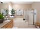 Elegant bathroom with granite vanity, soaking tub, and walk-in shower at 1942 W Peninsula Cir, Chandler, AZ 85248