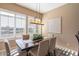 Elegant dining room with a large table, six chairs, and large windows at 1942 W Peninsula Cir, Chandler, AZ 85248