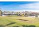 Picturesque view of a golf course and lake with houses in the background at 1942 W Peninsula Cir, Chandler, AZ 85248