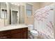 Clean bathroom with shower and floral curtain at 20515 N 264Th Ave, Buckeye, AZ 85396