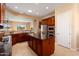 Spacious kitchen with island, stainless steel appliances, and dark wood cabinets at 20515 N 264Th Ave, Buckeye, AZ 85396