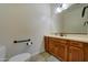 Neutral bathroom with wood cabinetry, bright lighting, and tile flooring provides a functional space at 20552 W Carlton Mnr, Buckeye, AZ 85396