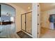 En suite bathroom with a glass-enclosed shower and walk-in closet, conveniently located near the bedroom at 20552 W Carlton Mnr, Buckeye, AZ 85396