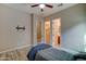 Cozy bedroom with light colored wood-look floors, ceiling fan, closet, and ensuite bathroom at 20552 W Carlton Mnr, Buckeye, AZ 85396