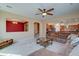 Spacious living room featuring plush furniture, an open layout, and modern ceiling fan at 20552 W Carlton Mnr, Buckeye, AZ 85396
