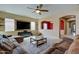 Open concept living room featuring cozy furniture, ceiling fan, carpet, and TV wall mount at 20552 W Carlton Mnr, Buckeye, AZ 85396