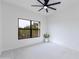 Bright bedroom featuring a ceiling fan and a large window at 21320 N 56Th St # 2001, Phoenix, AZ 85054