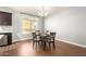 Bright dining area with wood floors and a four-person table at 2150 W Alameda Rd # 1112, Phoenix, AZ 85085