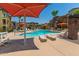 Community pool with lounge chairs and umbrellas at 2150 W Alameda Rd # 1112, Phoenix, AZ 85085