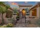 Charming entryway with an iron gate and lush desert plants at 21893 N 78Th St, Scottsdale, AZ 85255