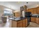 Spacious kitchen with island, wood cabinets, and stainless steel appliances at 21893 N 78Th St, Scottsdale, AZ 85255