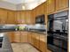 Kitchen features wood cabinets, stainless steel appliances, and tile flooring at 21893 N 78Th St, Scottsdale, AZ 85255