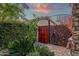 Private outdoor shower with stone wall and wooden gate at 21893 N 78Th St, Scottsdale, AZ 85255