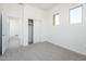 Bright bedroom with an ensuite entrance, closet, neutral carpet, and windows offering great lighting and view at 21916 W Duane Ln, Wittmann, AZ 85361