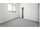 Bright, carpeted bedroom features a window with a view and a closet providing functionality and comfort at 21916 W Duane Ln, Wittmann, AZ 85361