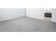 Spacious bedroom with neutral carpet, white walls, and an ensuite bathroom entrance, promoting relaxation at 21916 W Duane Ln, Wittmann, AZ 85361