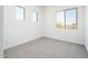 Comfortable bedroom with soft carpet, white walls, and several windows for natural light, creating a serene retreat at 21916 W Duane Ln, Wittmann, AZ 85361