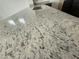 Close-up of a granite kitchen countertop featuring an undermount sink and dark wood cabinets in the background at 21916 W Duane Ln, Wittmann, AZ 85361