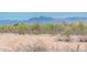 Scenic Arizona desert view with rugged mountains in the distance and natural desert vegetation at 21916 W Duane Ln, Wittmann, AZ 85361