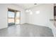 Dining room with grey tiled floors, modern lighting and access to the backyard at 21916 W Duane Ln, Wittmann, AZ 85361