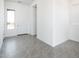 Bright entryway with gray tile flooring, white walls, and a modern white front door at 21916 W Duane Ln, Wittmann, AZ 85361