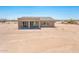 Back of home featuring a covered patio and desert landscaping at 21916 W Duane Ln, Wittmann, AZ 85361
